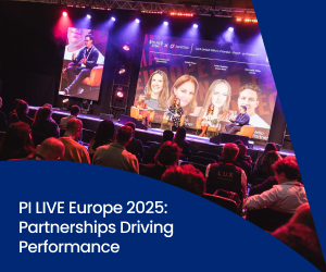 Panel discussion on stage at PI LIVE Europe 2025 with industry experts speaking on partnerships driving performance, viewed by a seated audience under event lighting